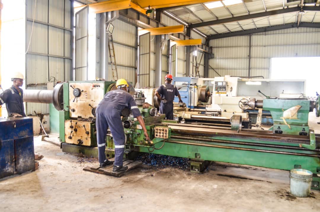 Reveille technicians cutting a thread on a heavy-duty lathe